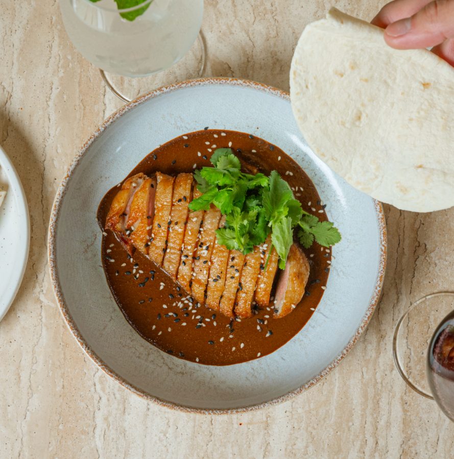 Sliced grilled pork with rocket in a rich sauce at Angelica Norwest