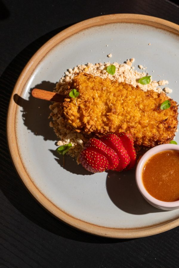 Crumbed dessert with strawberries and a dipping sauce at Lucky You Darling
