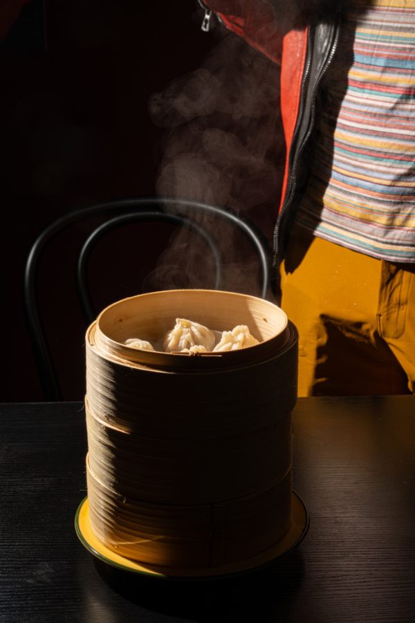 Steamed dumplings in a bamboo basket at Lucky You Darling
